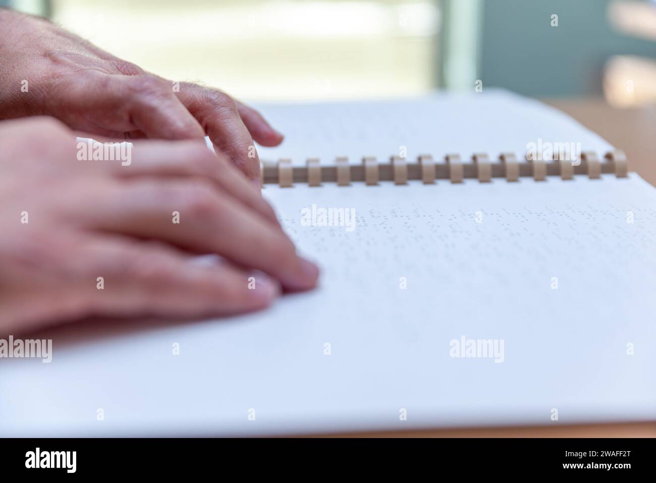 Blind or visually impaired person reading a book printed with braille characters Stock Photo Alamy