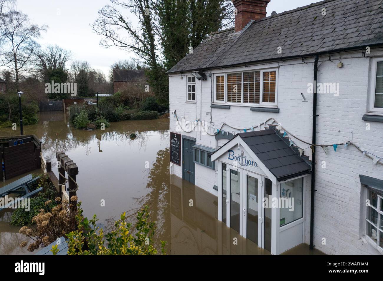 Bridgnorth, Shropshire, January 4th 2024 - Storm Henk flooding continues to affect areas along the River Severn. Bridgnorth also saw devastating flooding with rugby pitches under several feet and water lapping at the tyres of an American muscle car. River levels are expect to peak very close to record heights on Friday morning. Credit: Stop Press Media/Alamy Live News Stock Photo