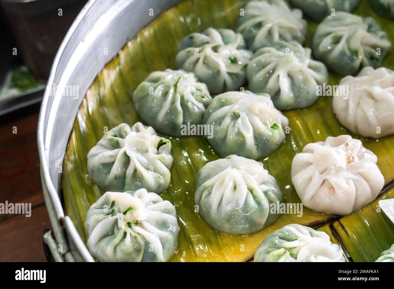 Pork and chives dumplings on banana leaves. Traditional Thai Street