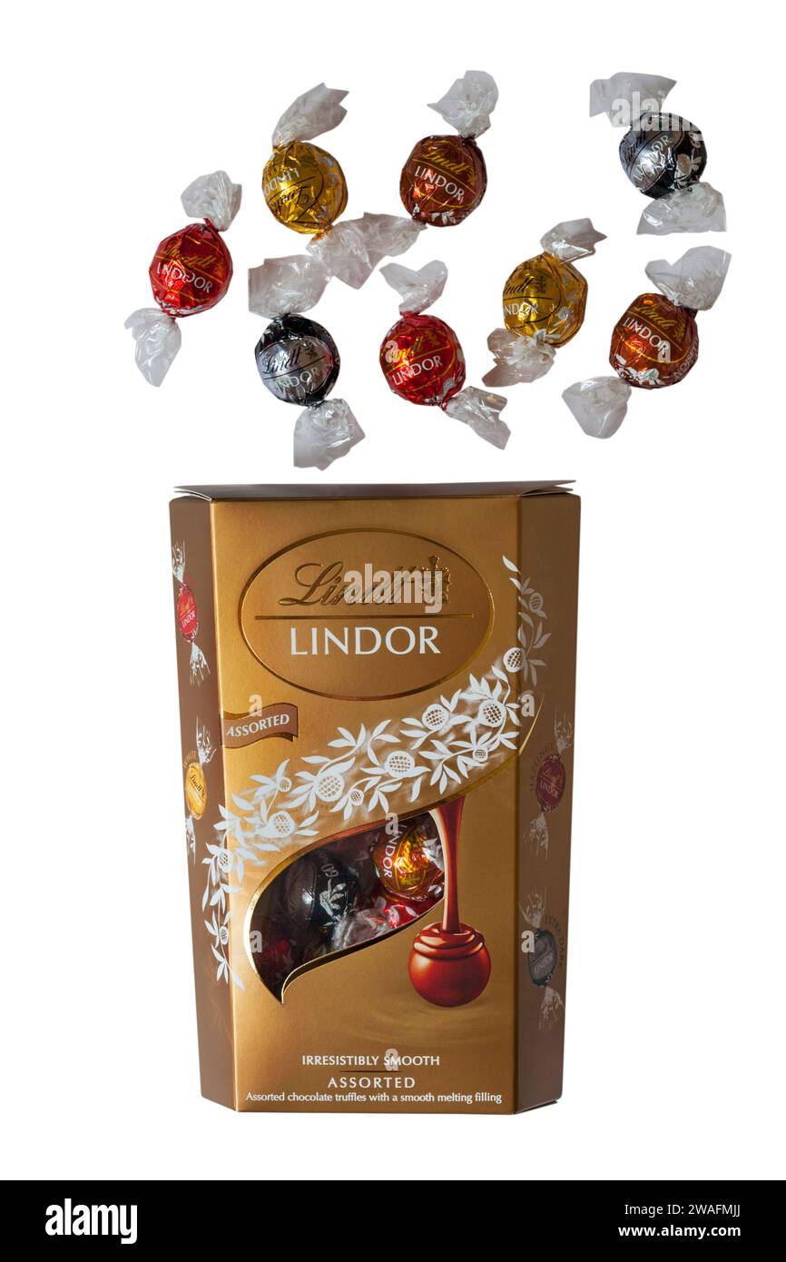 Box of Lindt Lindor Assorted irresistibly smooth assorted truffles with a smooth melting filling with contents spilt isolated on white background Stock Photo