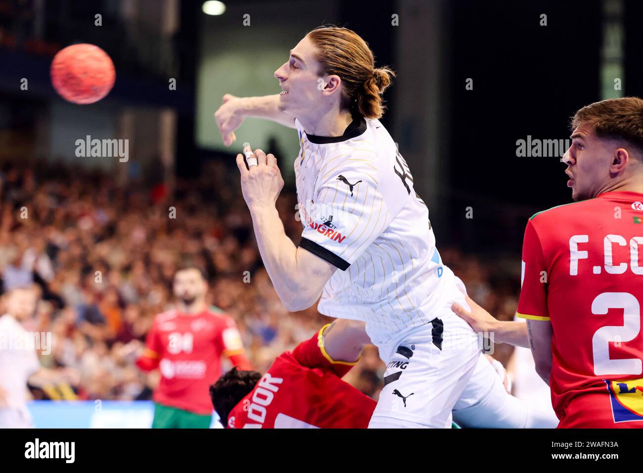 Flensburg, Germany. 04th Jan, 2024. Handball: International match, Germany - Portugal. Germany's Juri Knorr (center) prevails against Portugal's Francisco Costa (right). Credit: Frank Molter/dpa/Alamy Live News Stock Photo