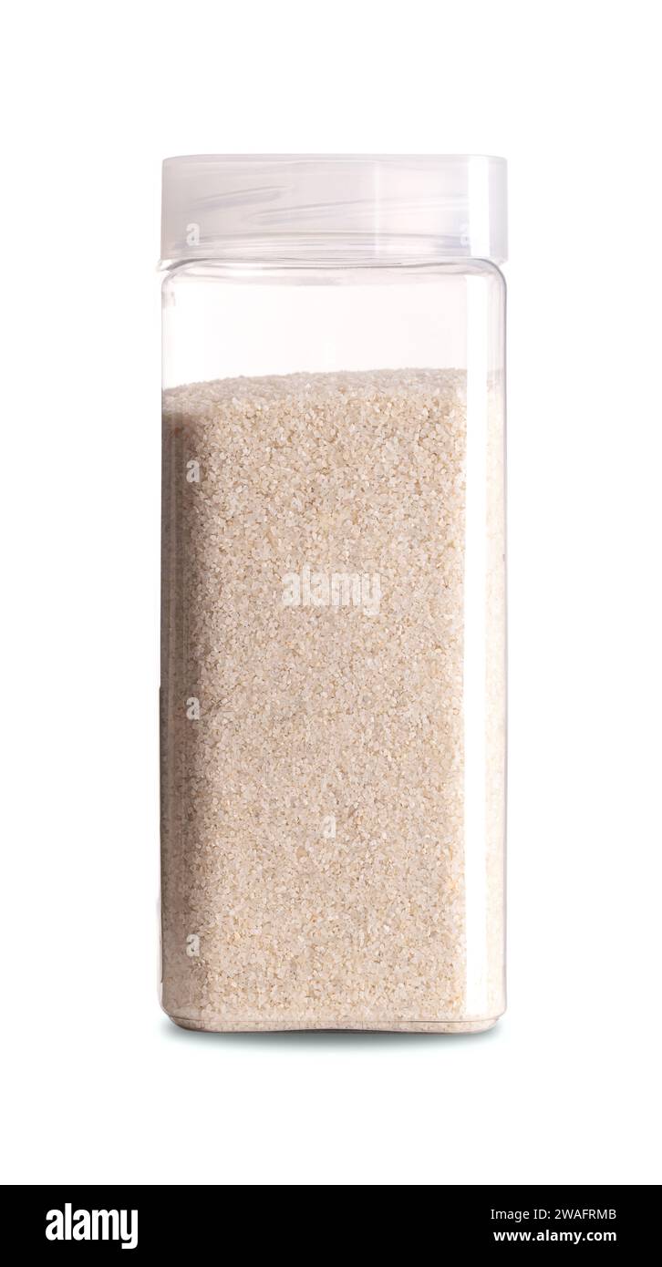 Fine sand in a plastic container. Cream colored, smooth and fine-grained sand. Close-up, front view, on white background, photo. Stock Photo