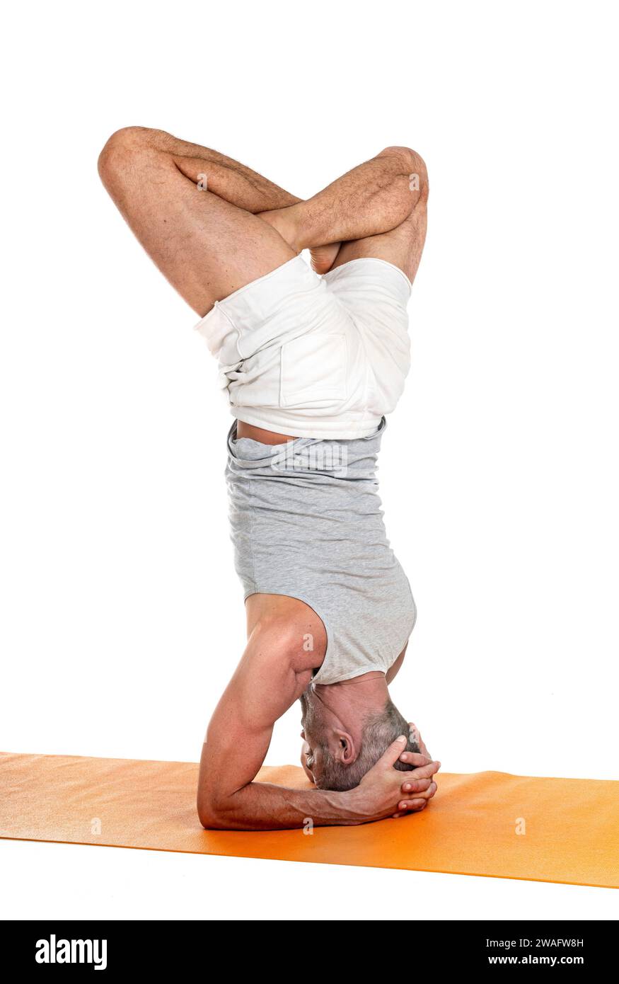 man and hatha yoga asana in front of white background Stock Photo
