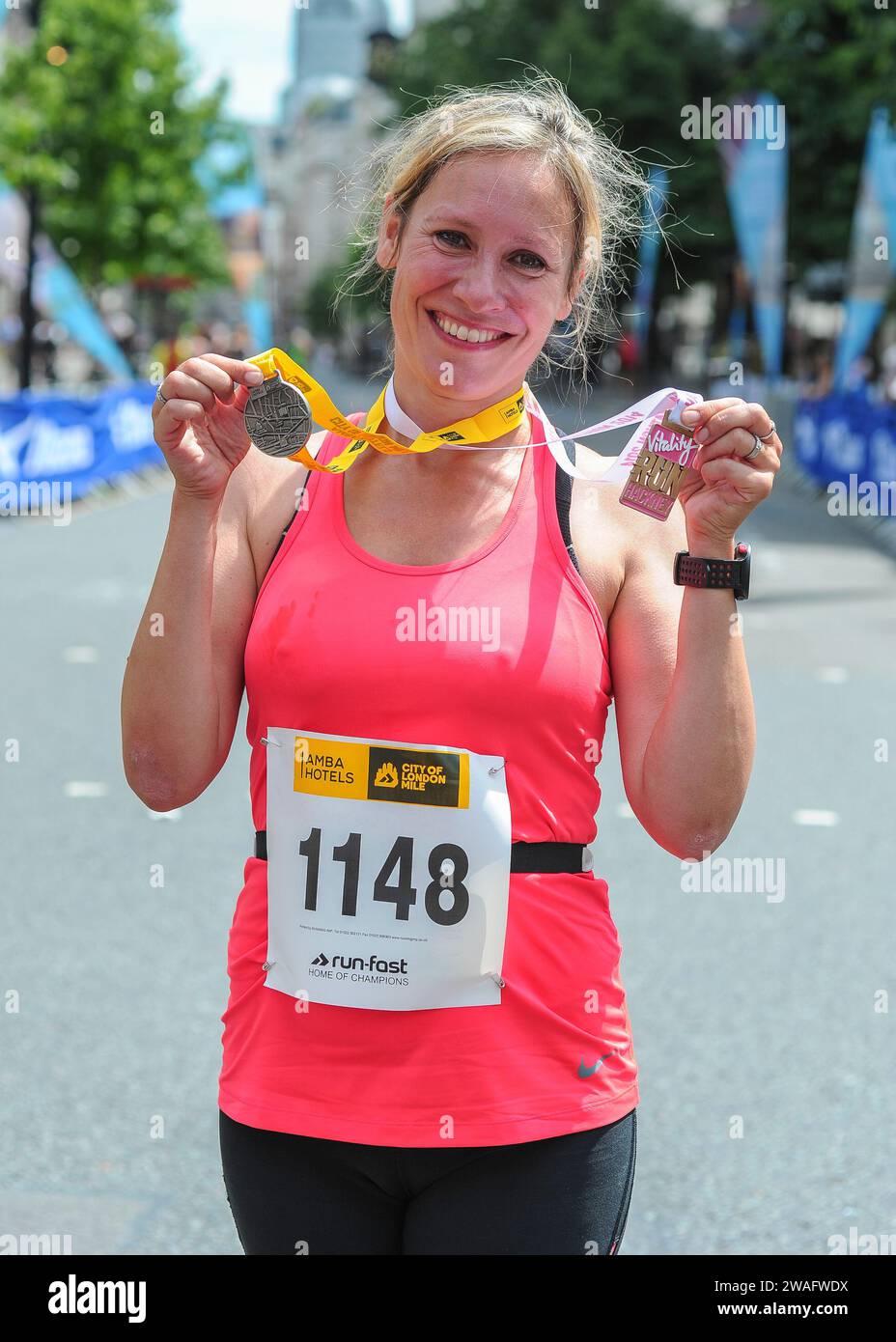 Sophie Jane Raworth journalist, newsreader and broadcaster receives her medals after competing in the Vitality Westminster half marathon, London UK on Stock Photo