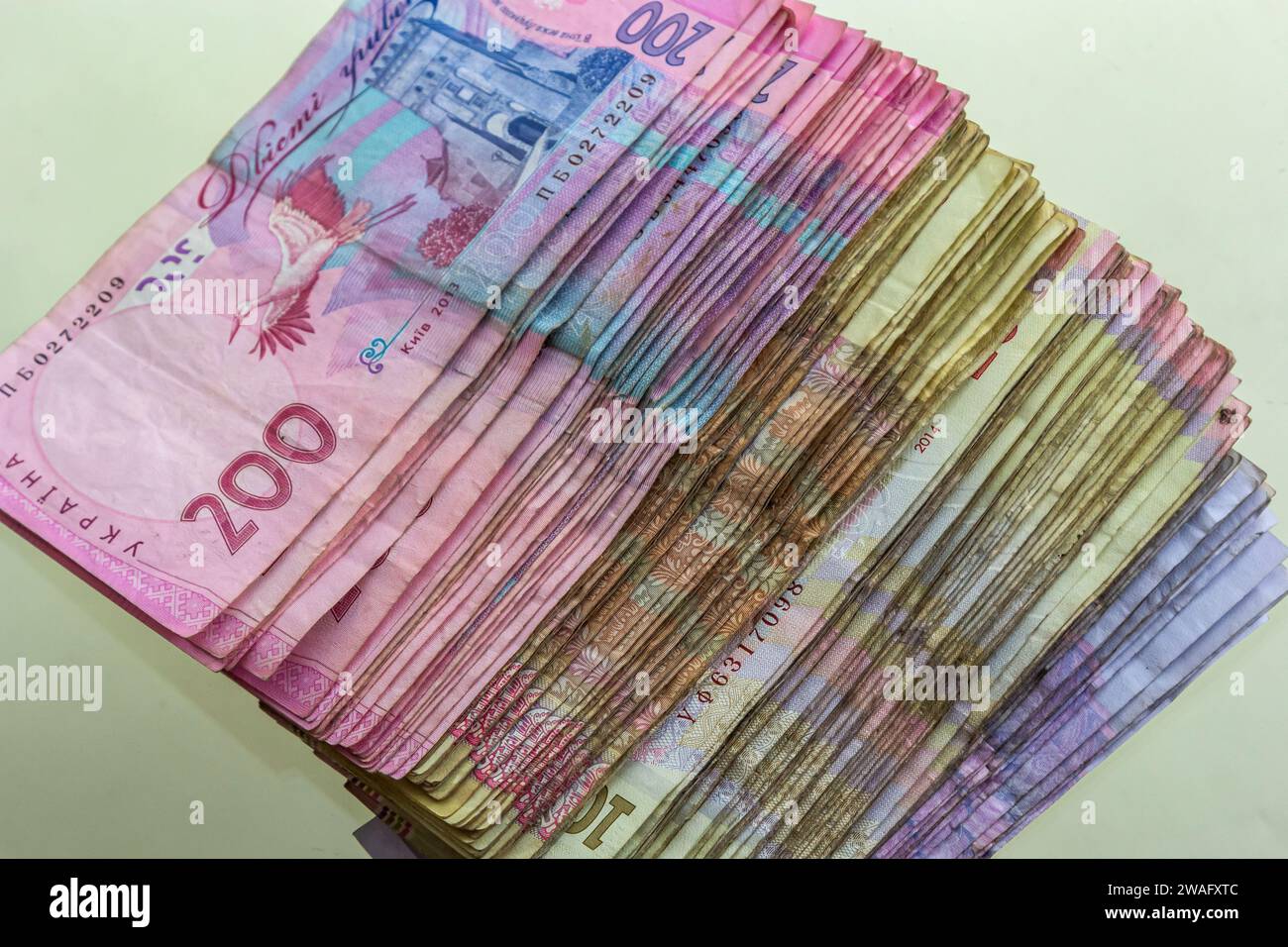 Ukrainian paper money is laid out on a blue background. 200 hryvnia banknotes. Stock Photo