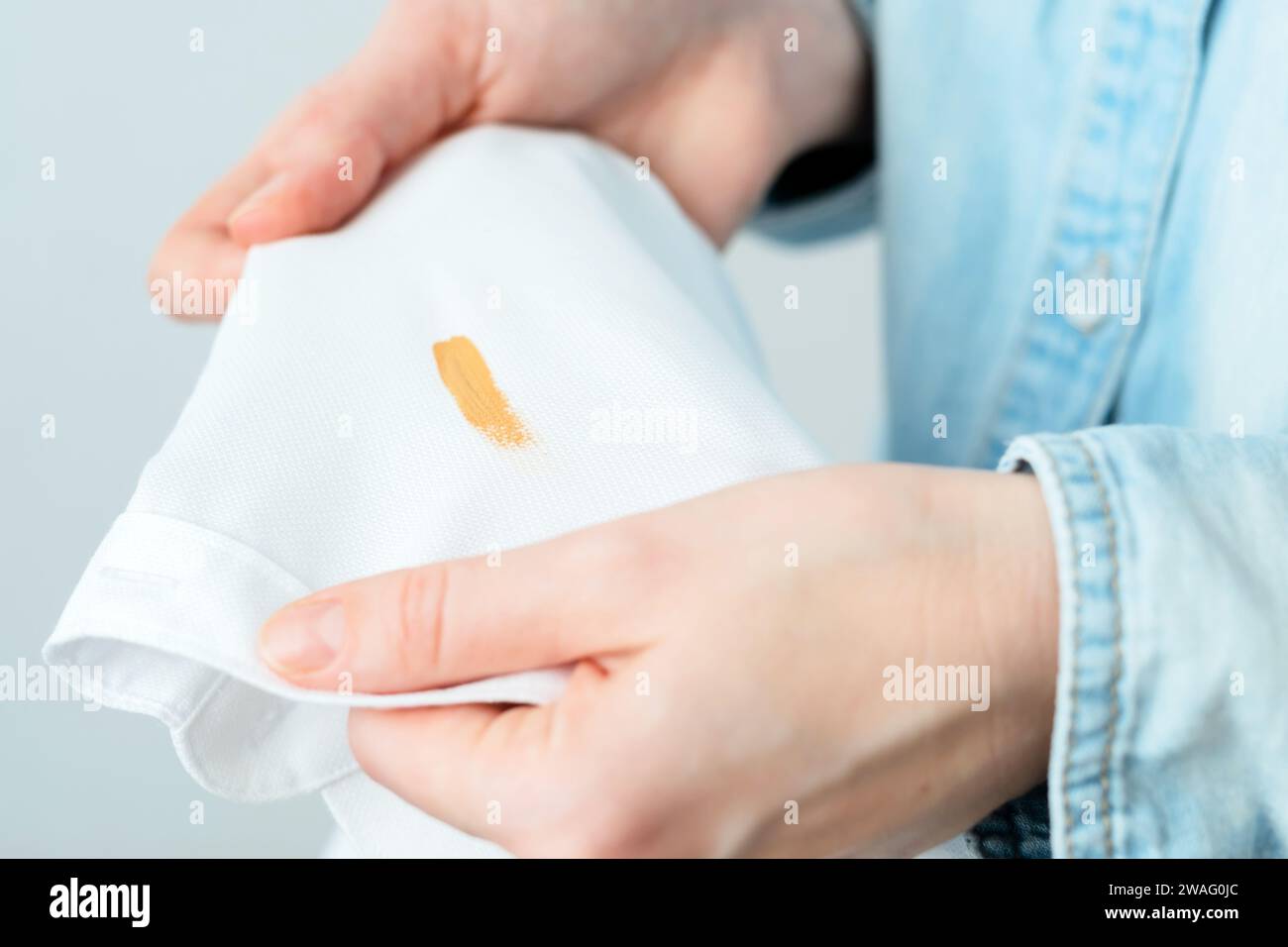 Cosmetic stains on the white clothes. The housewife evaluates the stain