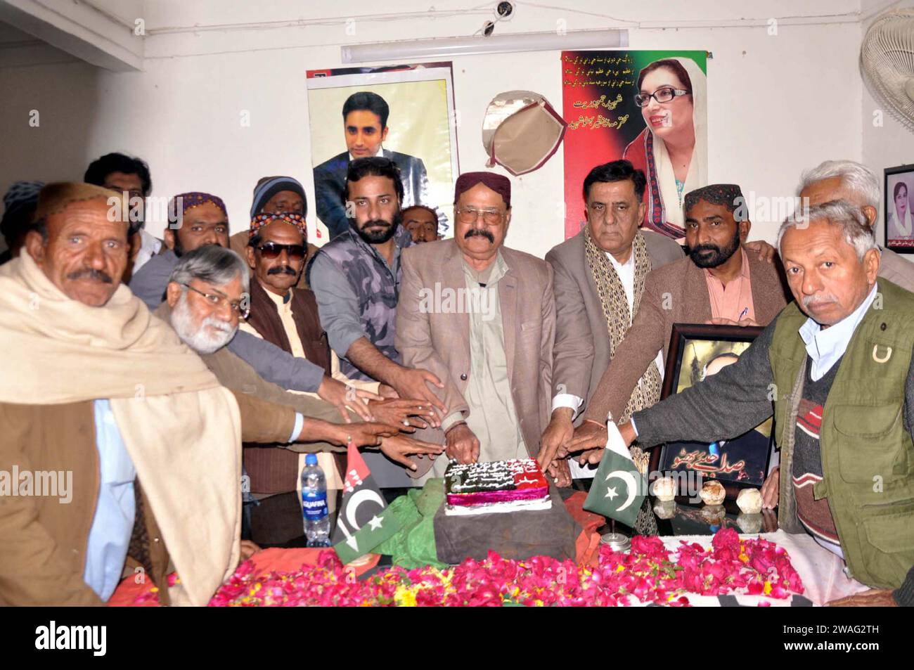 Leaders and activists of Peoples Party (PPP) are cutting cake as they are marking 96th Birthday Anniversary of Zulfiqar Ali Bhutto, during celebration ceremony held in Hyderabad on Thursday, January 4, 2024. Stock Photo
