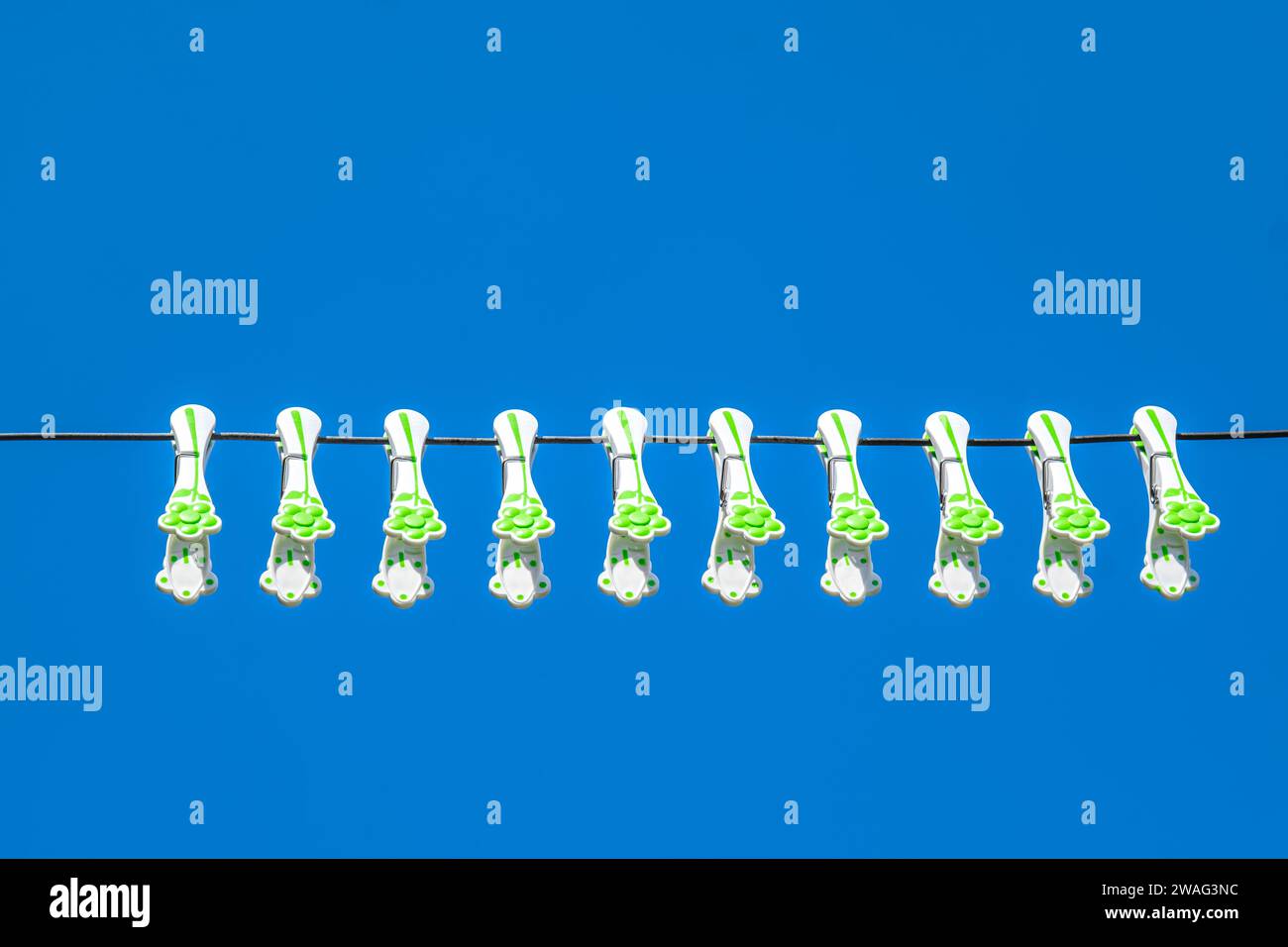 plastic laundry clothes hooks on the wire with blue sky Stock Photo