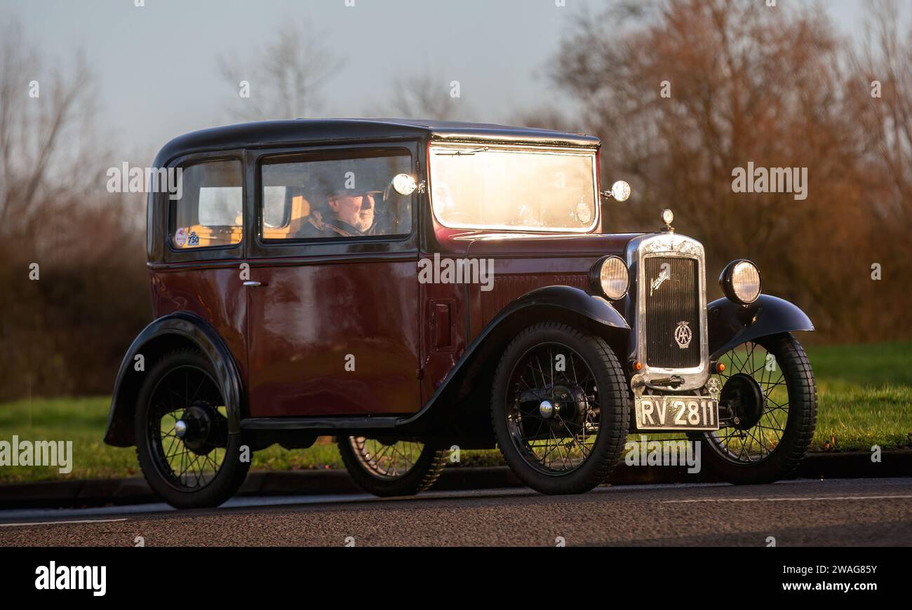Stony Stratford,UK Jan 1st 2024. 1932 maroon Austin Seven car arriving at Stony Stratford for the annual New Years Day vintage and classic vehicle fes Stock Photo