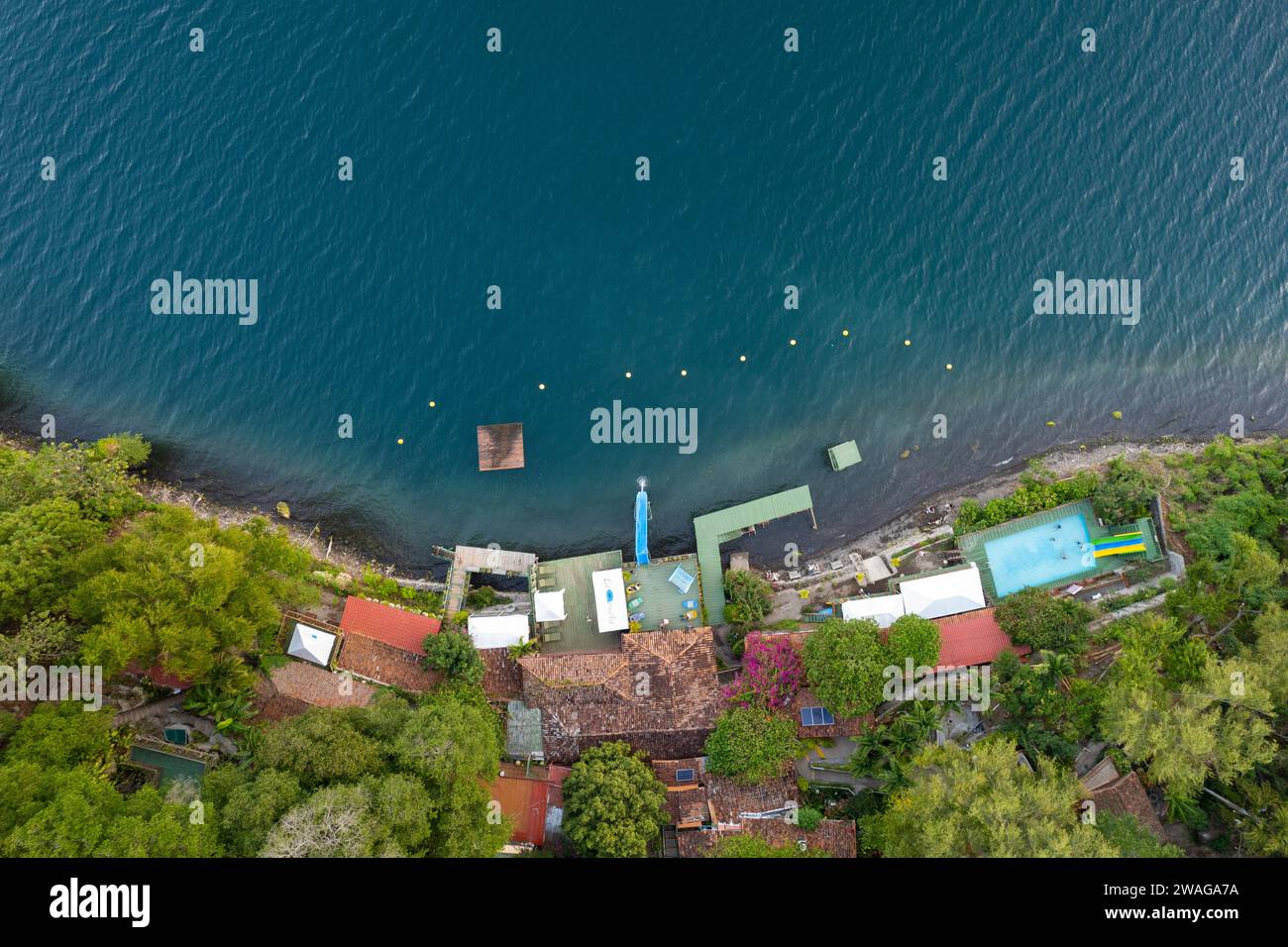 Hotel with pool on green lagoon beach aerial above top drone view Stock Photo