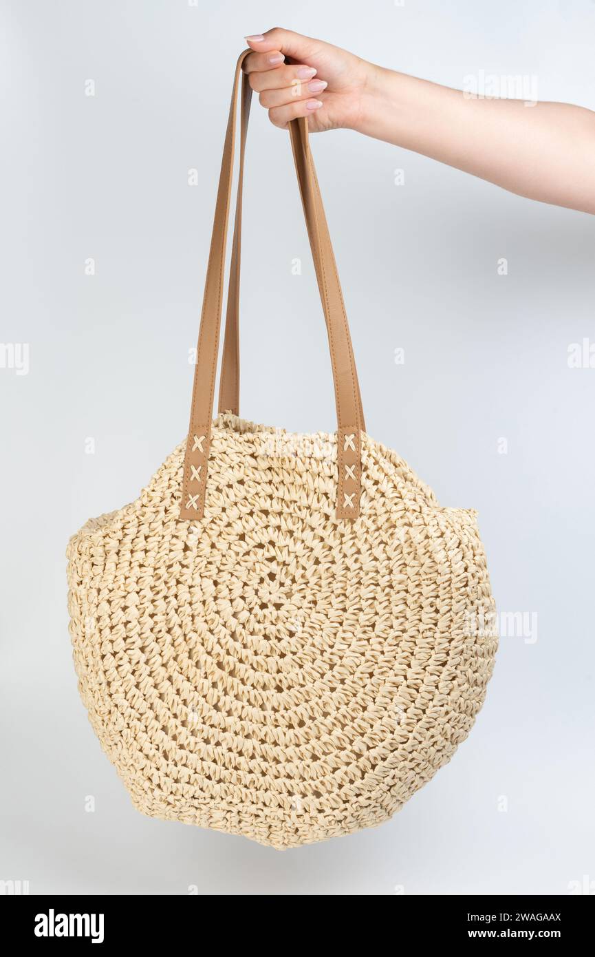 Trendy beige color summer woman bag from straw material Stock Photo