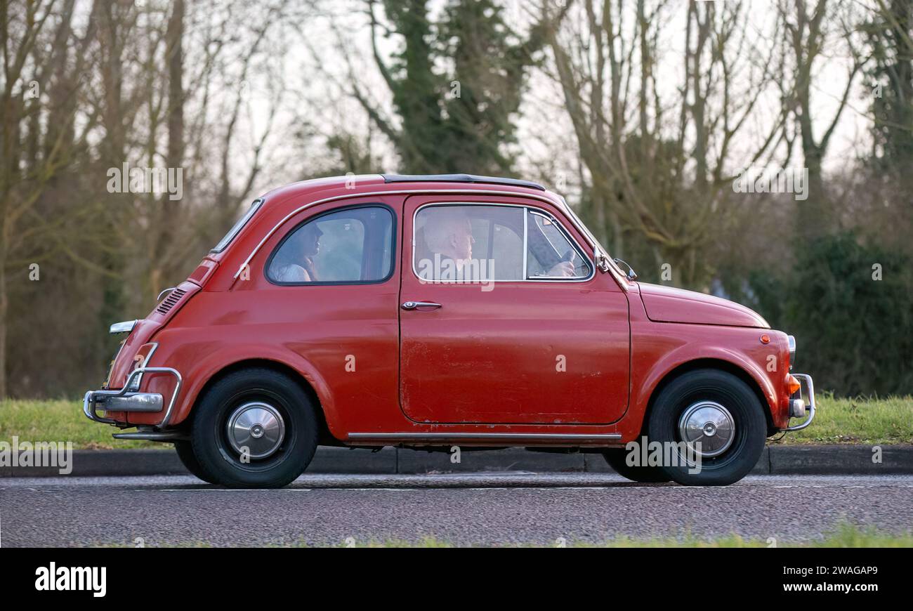 Stony Stratford,UK Jan 1st 2024. 1972 red Fiat 500 classic car arriving at Stony Stratford for the annual New Years Day vintage and classic vehicle fe Stock Photo