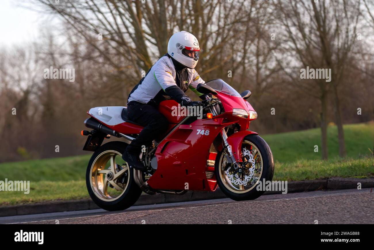Stony Stratford,UK Jan 1st 2024.2000 red Ducati 748 motorcycle arriving at Stony Stratford for the annual New Years Day vintage and classic vehicle fe Stock Photo