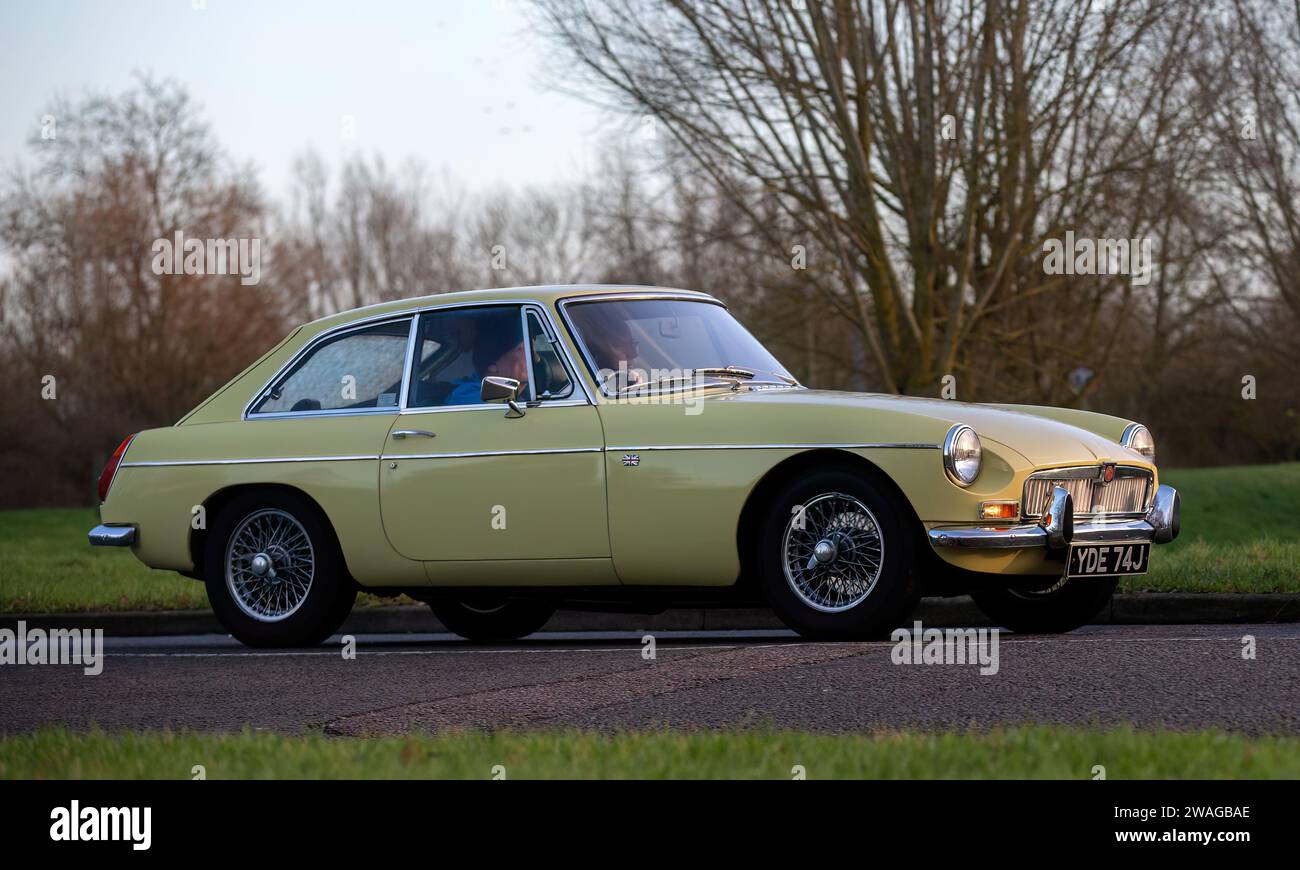 Stony Stratford,UK Jan 1st 2024.1970 yellow MG B GT sports car arriving
