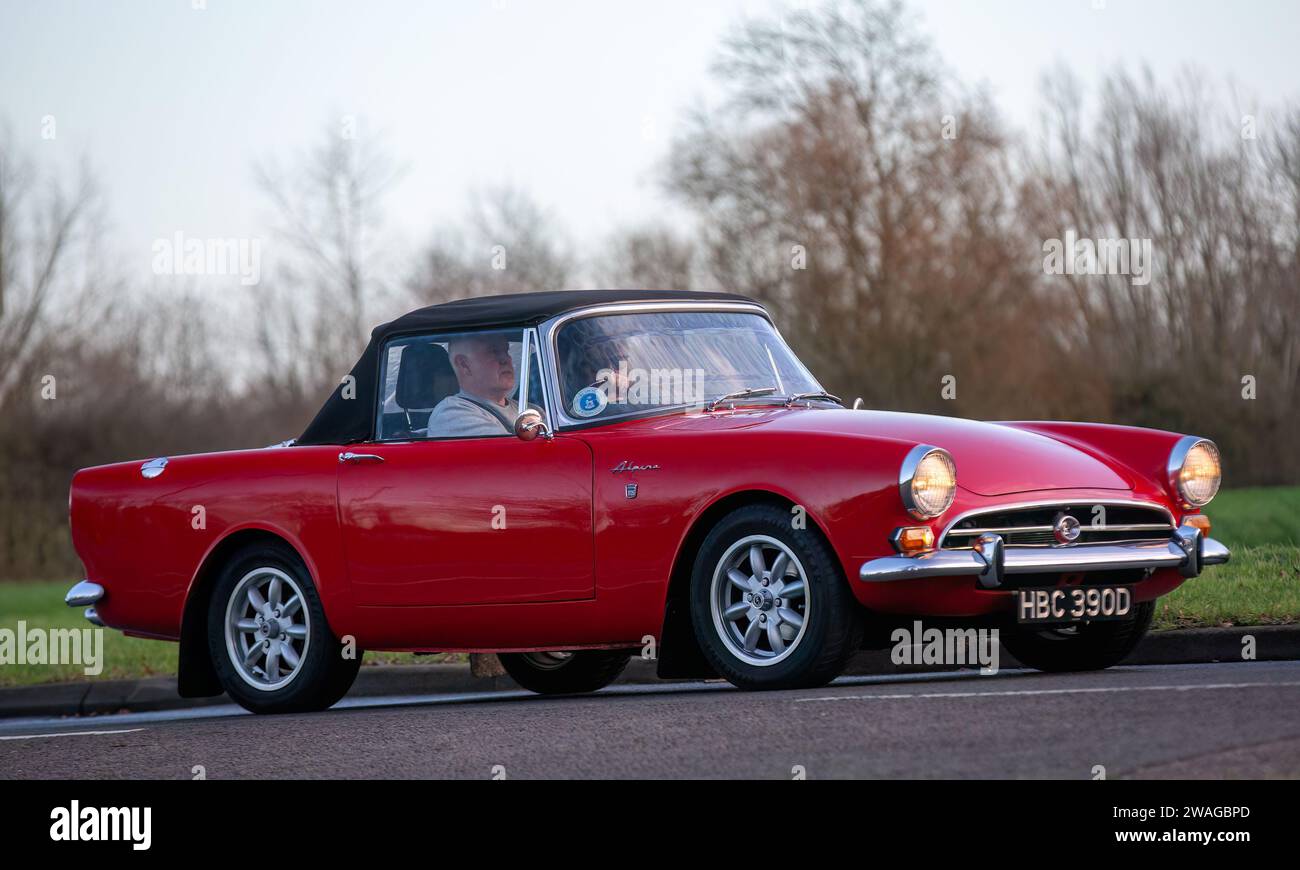 Stony Stratford,UK Jan 1st 2024.  1966 red Sunbeam Alpine sports car arriving at Stony Stratford for the annual New Years Day vintage and classic vehi Stock Photo