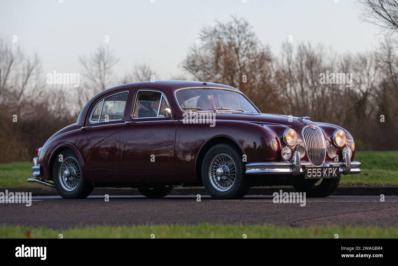 Stony Stratford,UK Jan 1st 2024. 1958 maroon Jaguar mk1 car arriving at Stony Stratford for the annual New Years Day vintage and classic vehicle festi Stock Photo