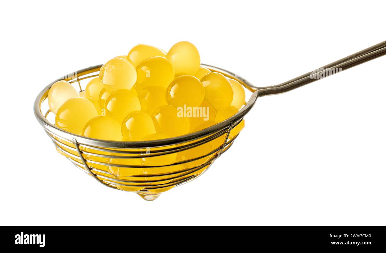 yellow jelly balls for making bubble tea in strainer isolated on white