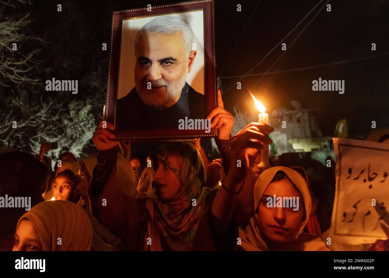 Kashmiri Shia Muslim holds a photograph of Iranian general Qassem ...