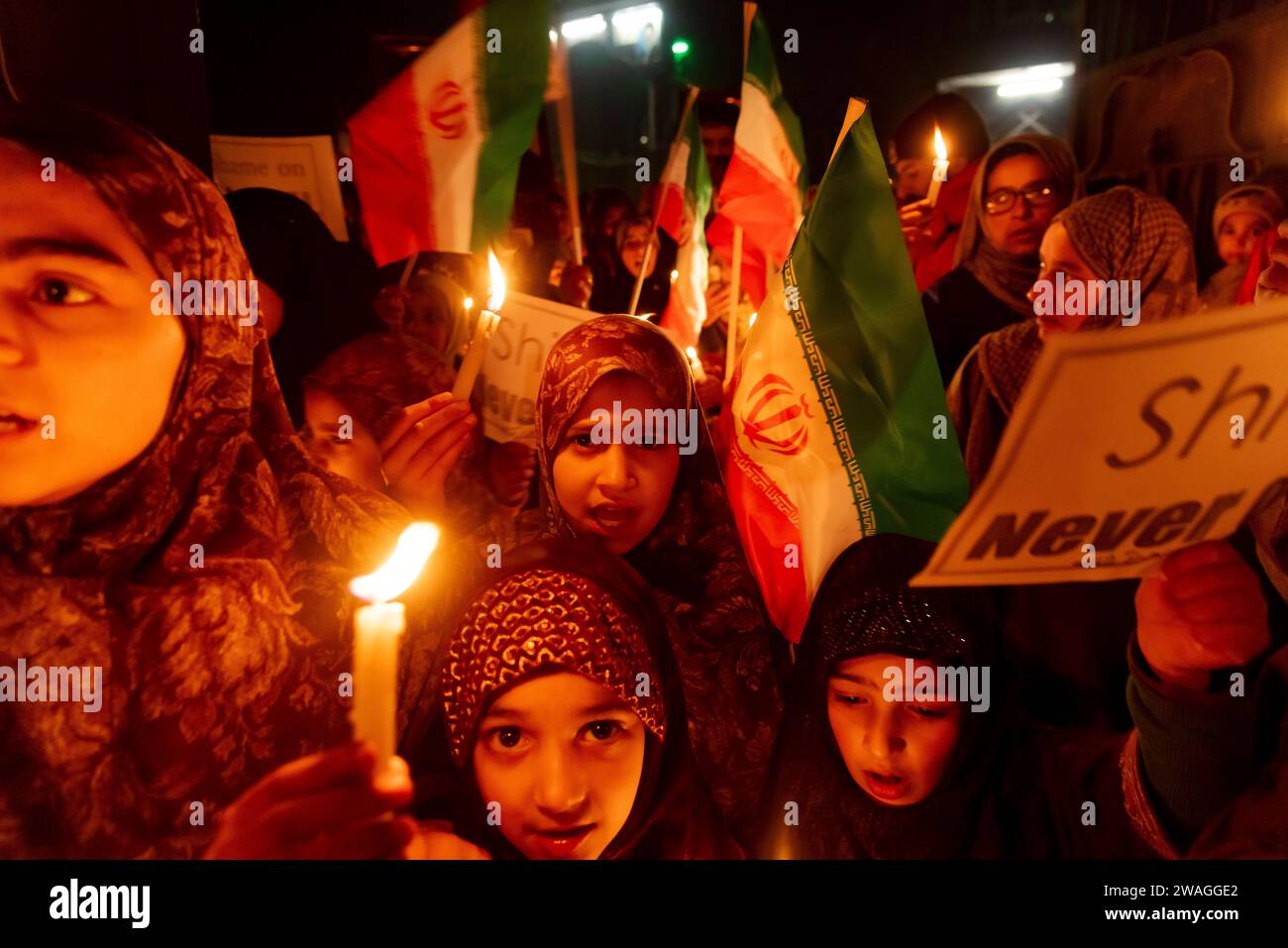 Kashmiri Shia Muslims hold placards and Iranian flags as they shout ...