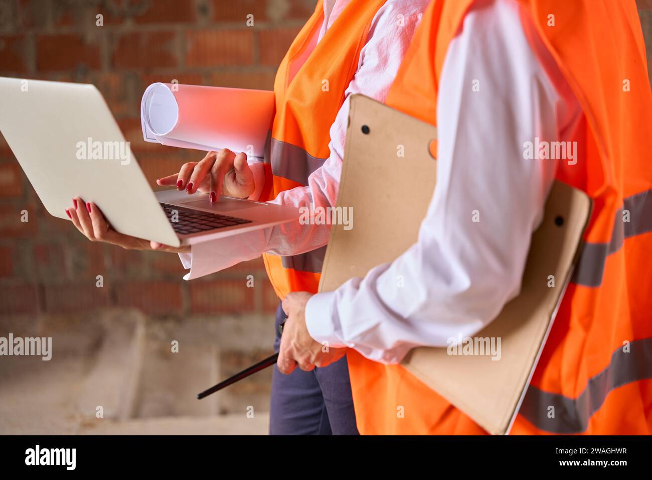 Construction specialists using computer during inspection of building Stock Photo