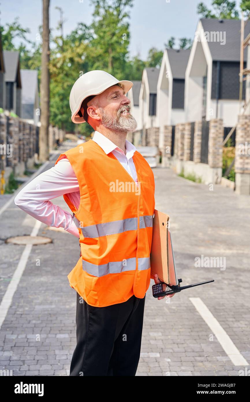 Joyous construction supervisor performing inspection of residential ...