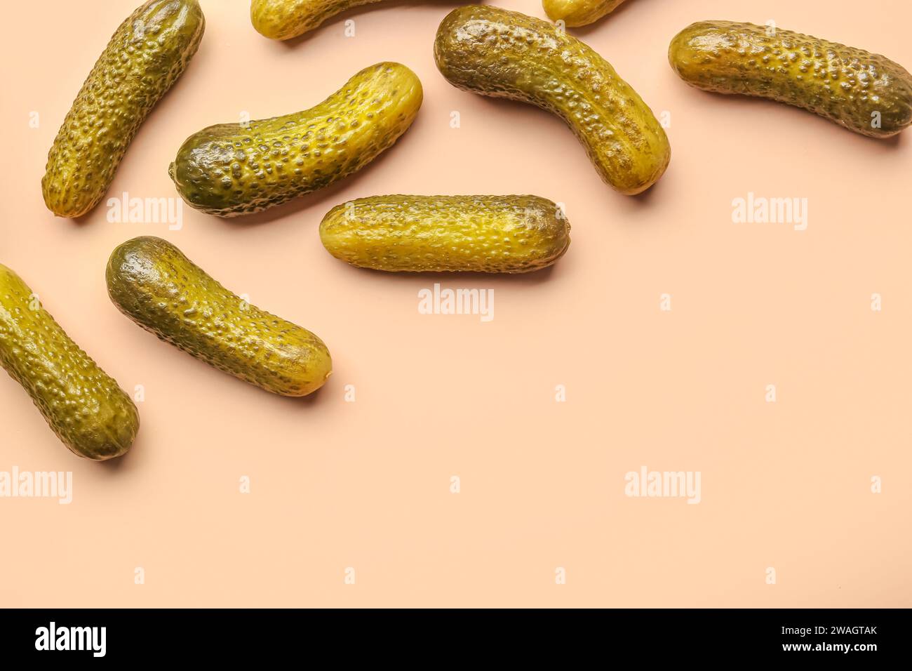 Pickled cucumbers on orange background Stock Photo