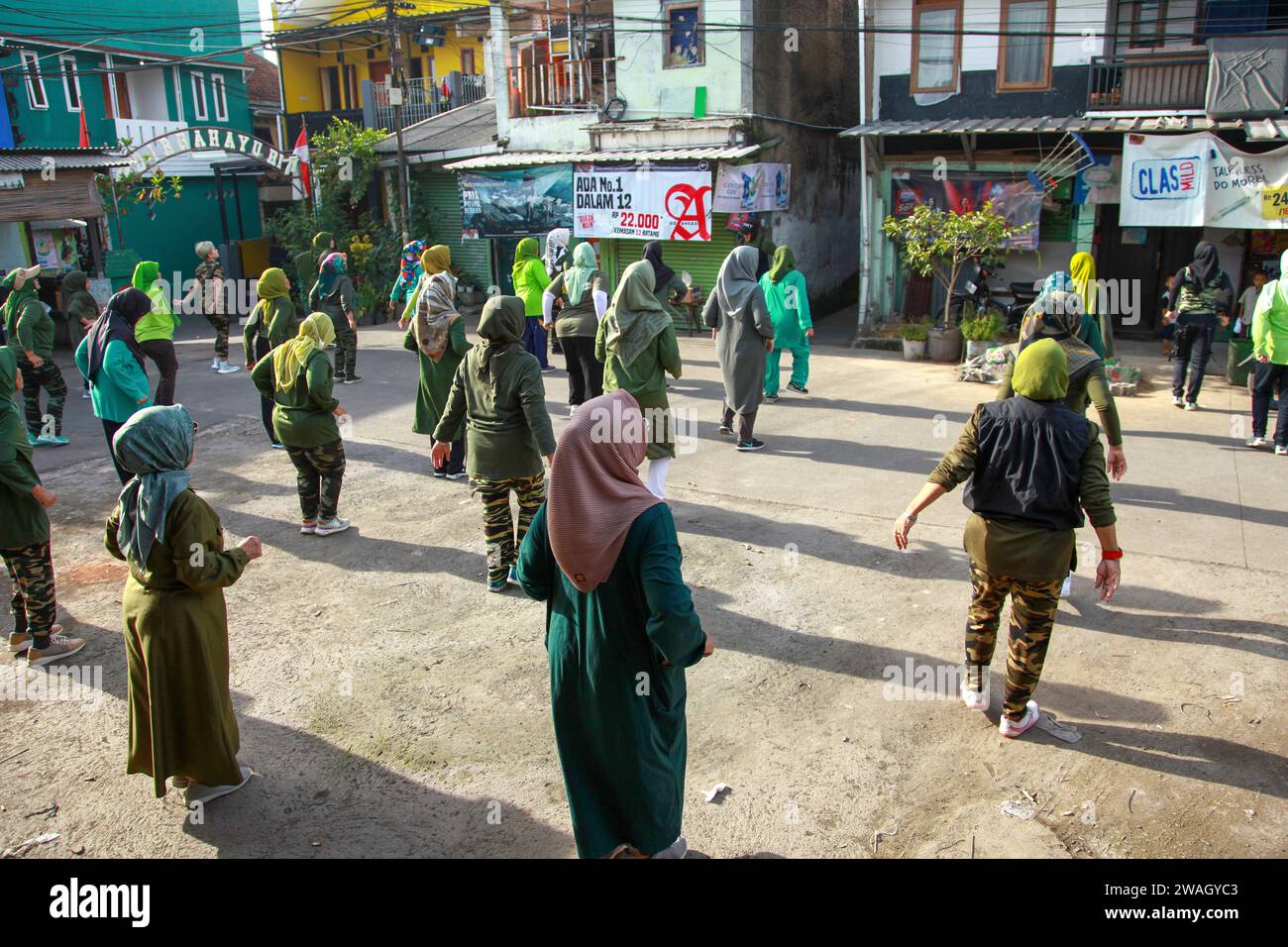 Muslim Women doing early morning Aerobics. The women are mostly middle-aged and wearing military fatigues. Stock Photo