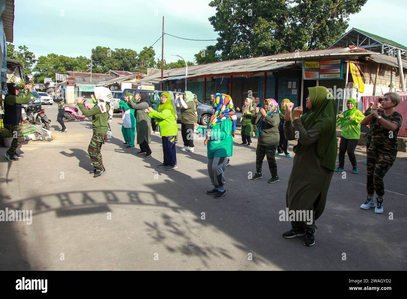 Muslim Women doing early morning Aerobics. The women are mostly middle-aged and wearing military fatigues. Stock Photo