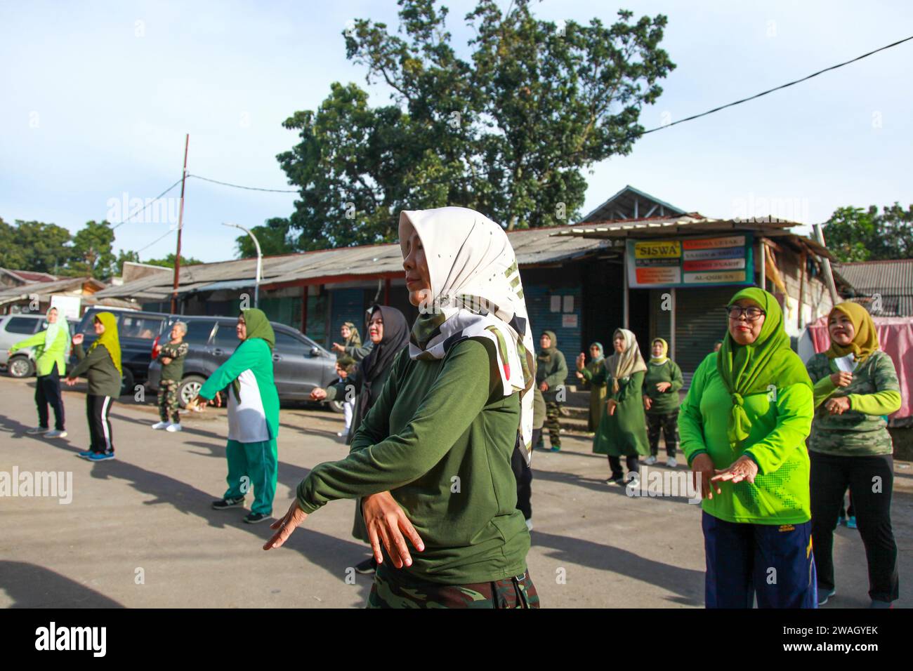 Muslim Women doing early morning Aerobics. The women are mostly middle-aged and wearing military fatigues. Stock Photo