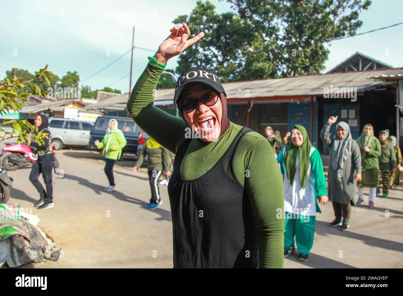 Muslim Women doing early morning Aerobics. The women are mostly middle-aged and wearing military fatigues. Stock Photo