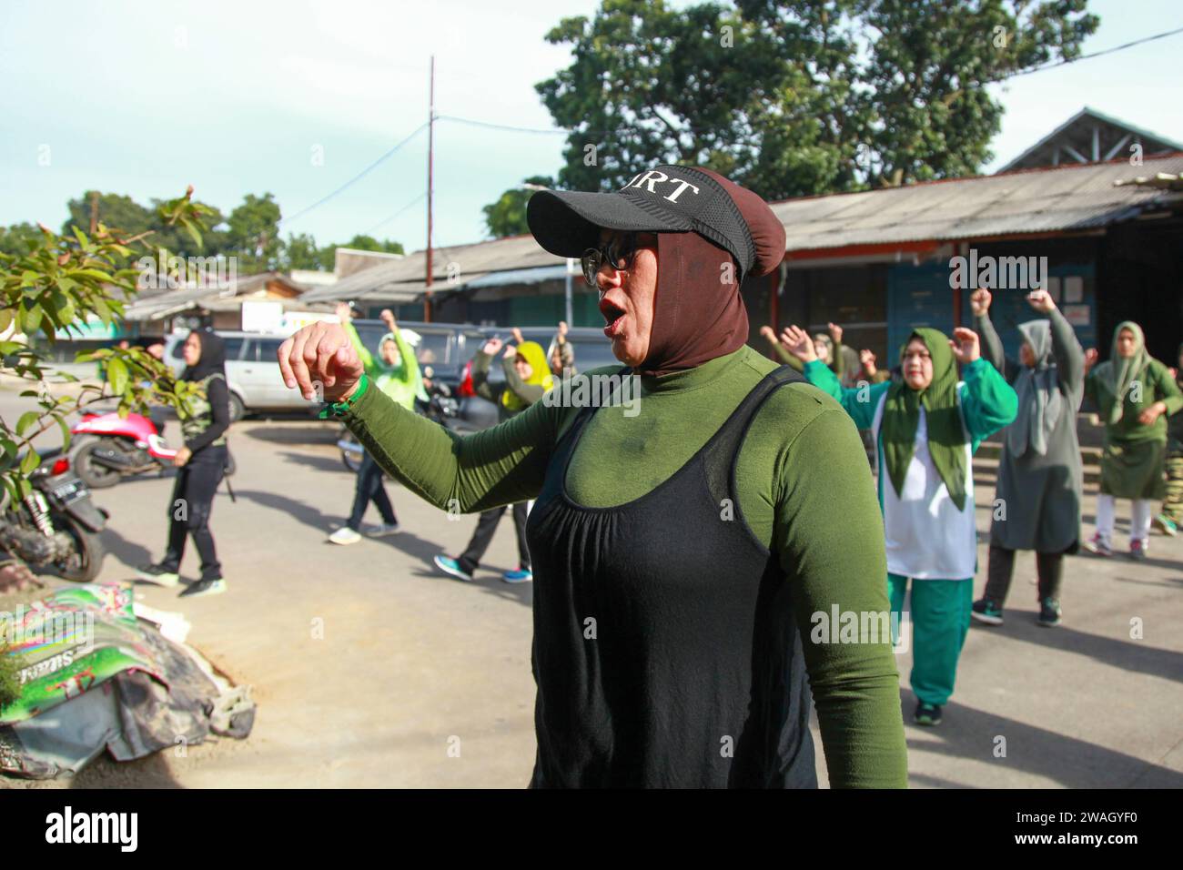 Muslim Women doing early morning Aerobics. The women are mostly middle-aged and wearing military fatigues. Stock Photo