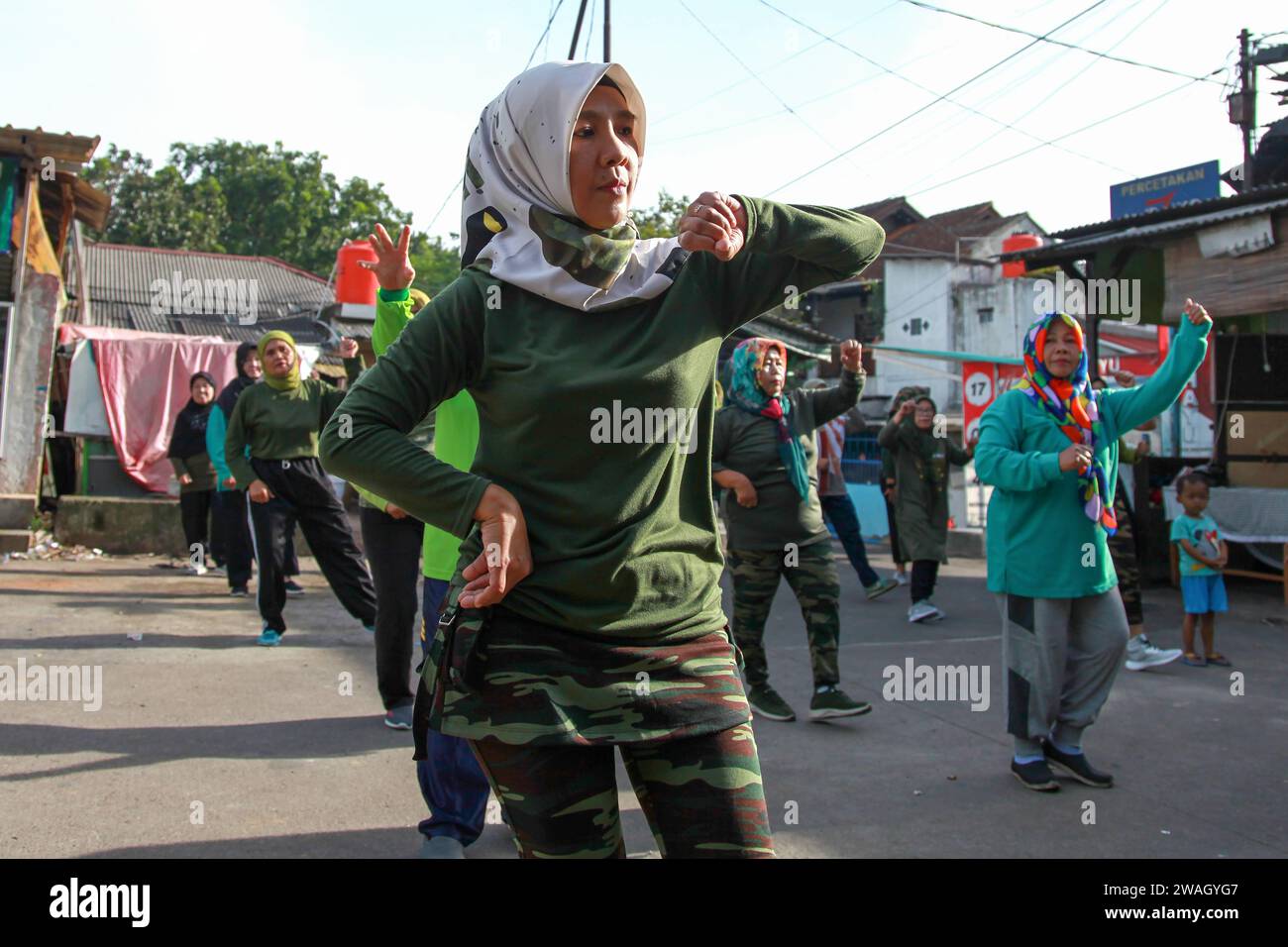 Muslim Women doing early morning Aerobics. The women are mostly middle-aged and wearing military fatigues. Stock Photo