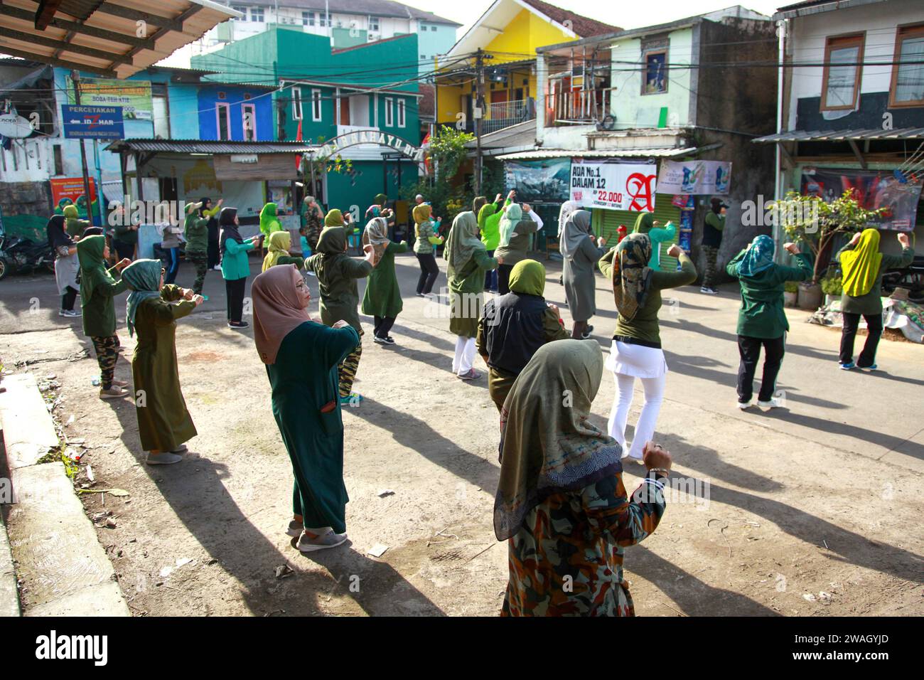 Muslim Women doing early morning Aerobics. The women are mostly middle-aged and wearing military fatigues. Stock Photo