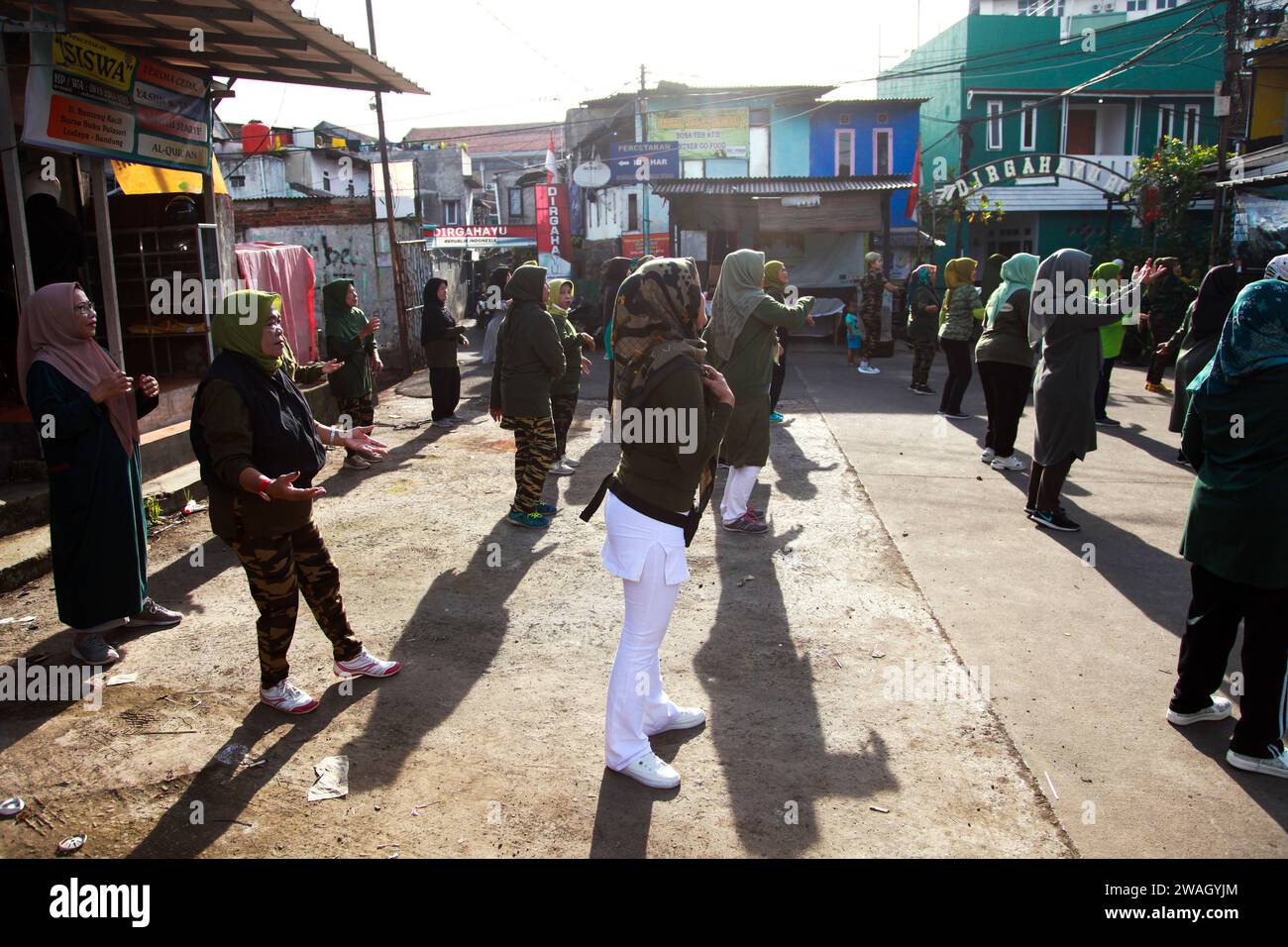 Muslim Women doing early morning Aerobics. The women are mostly middle-aged and wearing military fatigues. Stock Photo