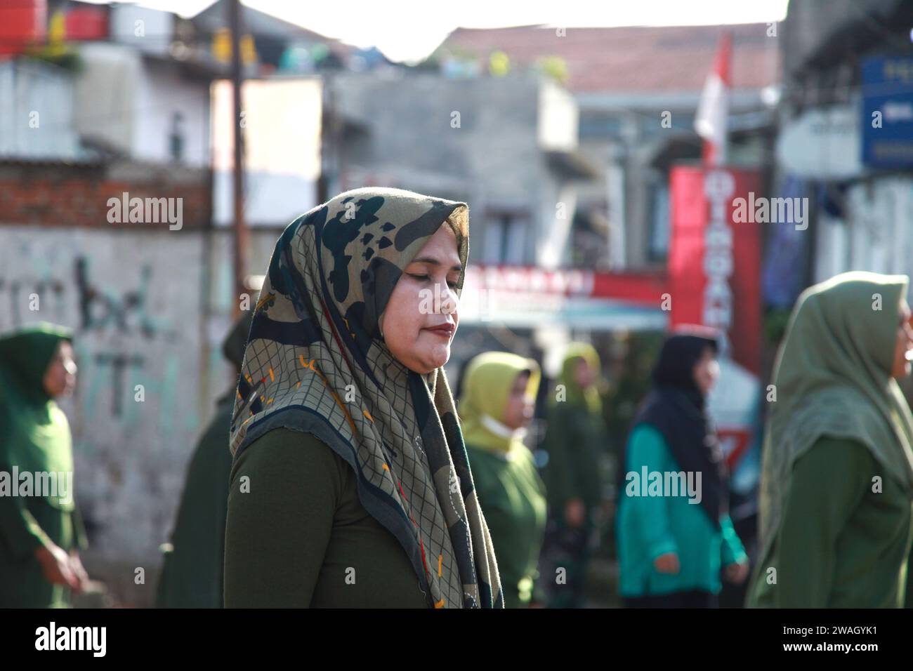 Muslim Women doing early morning Aerobics. The women are mostly middle-aged and wearing military fatigues. Stock Photo