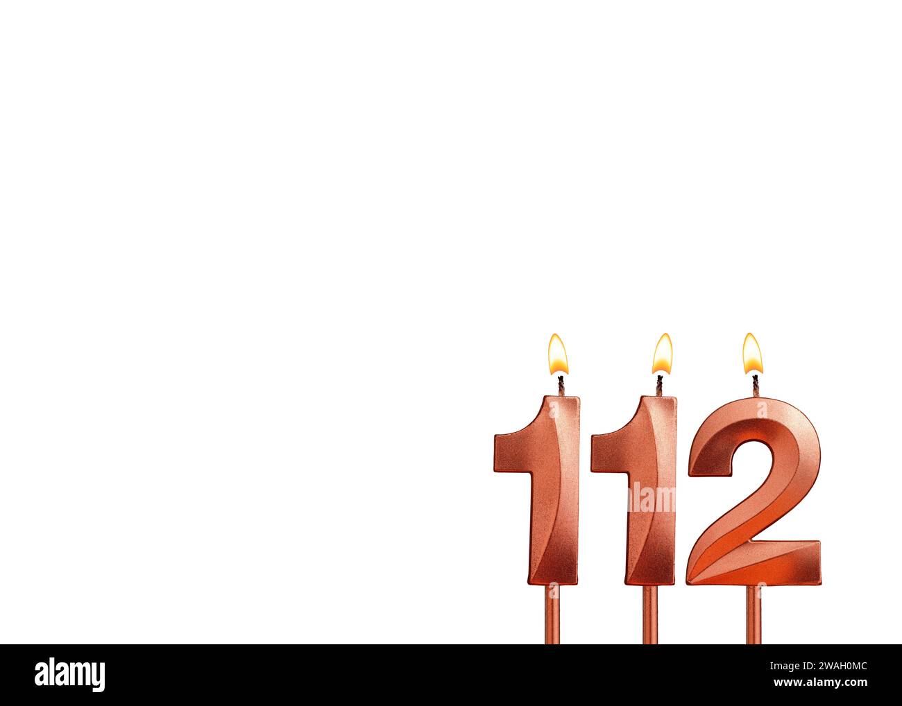 Burning candle number 112 for birthday on white background Stock Photo