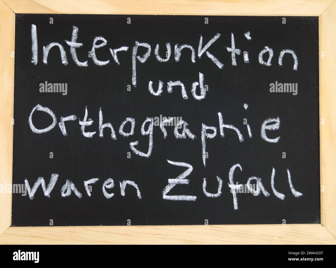 black board with the inscription 'Punctuation and spelling were a coincidence' at the end of a presentation Stock Photo