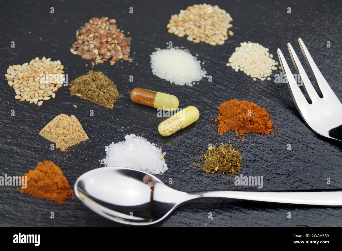 Nutritional supplements in pills with spoon and fork Stock Photo