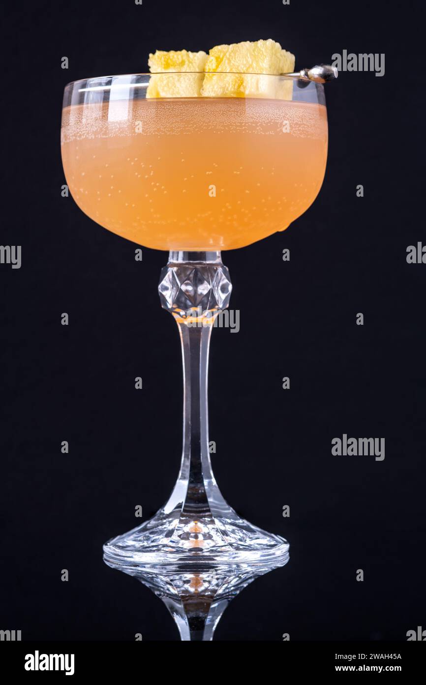 Only fans Martini cocktail garnished with pineapple cubes Stock Photo