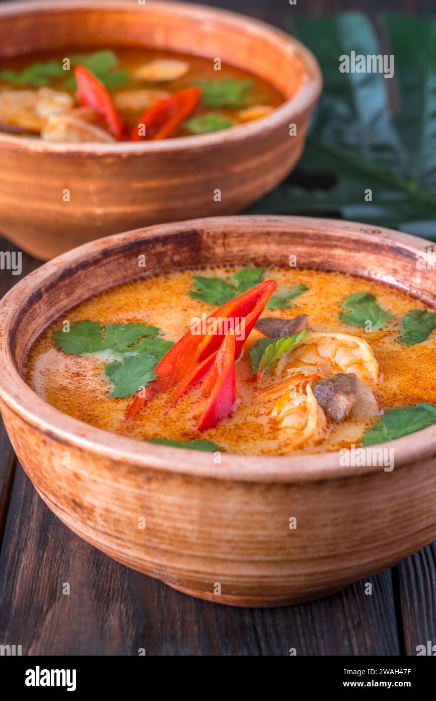 Bowls of tom yum soup on wooden background Stock Photo