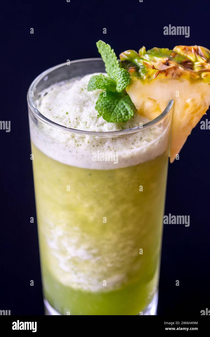 Missionary's Downfall cocktail garnished with pineapple wedge Stock Photo