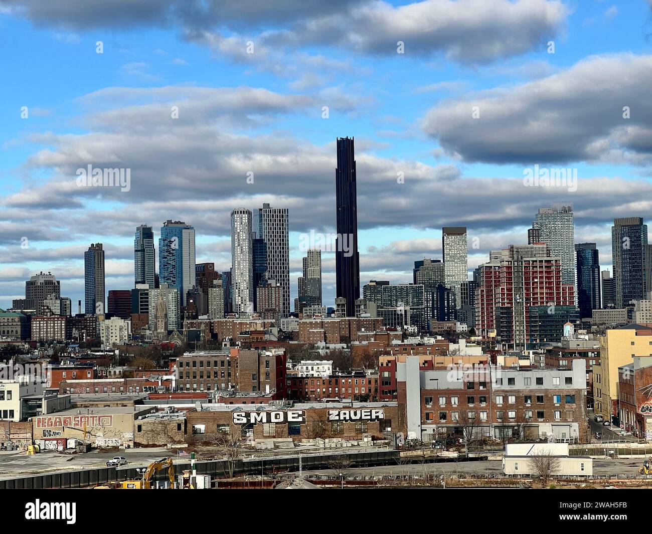 View of the Downtown Brooklyn ever growing skyline from the elevated Smith 9th Street elevated subway Station platform across residential neighborhoods in Brooklyn, New York City. Stock Photo