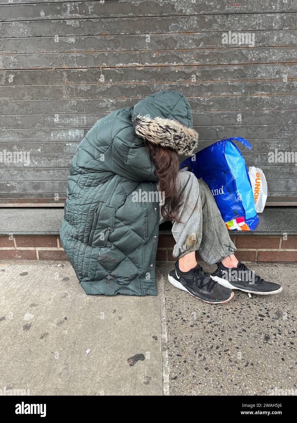 Withdrawn young woman on the sidewalk in Brooklyn, New York. Stock Photo
