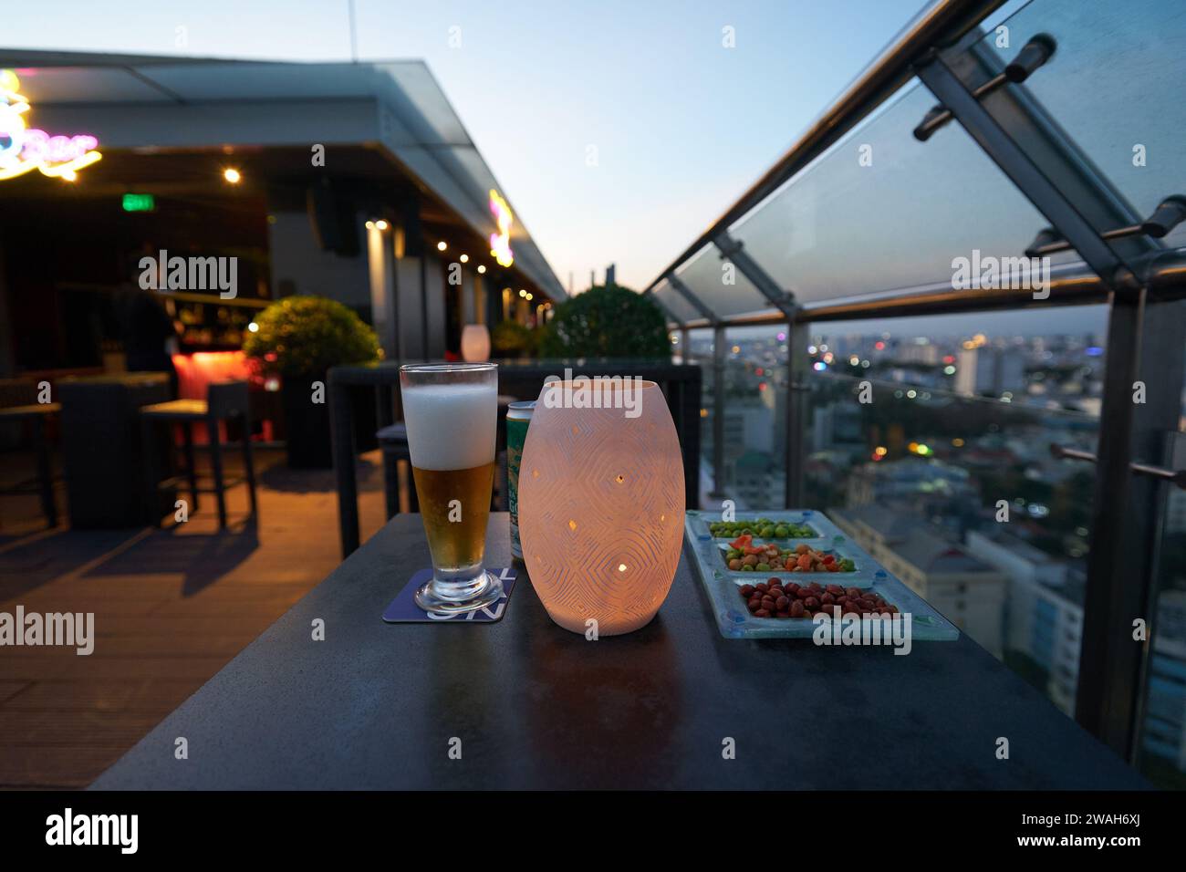 HO CHI MINH CITY, VIETNAM - MARCH 26, 2023: beer and snacks served on a table at outdoor terrace of OnTop Bar, a rooftop bar located on the 20th floor Stock Photo