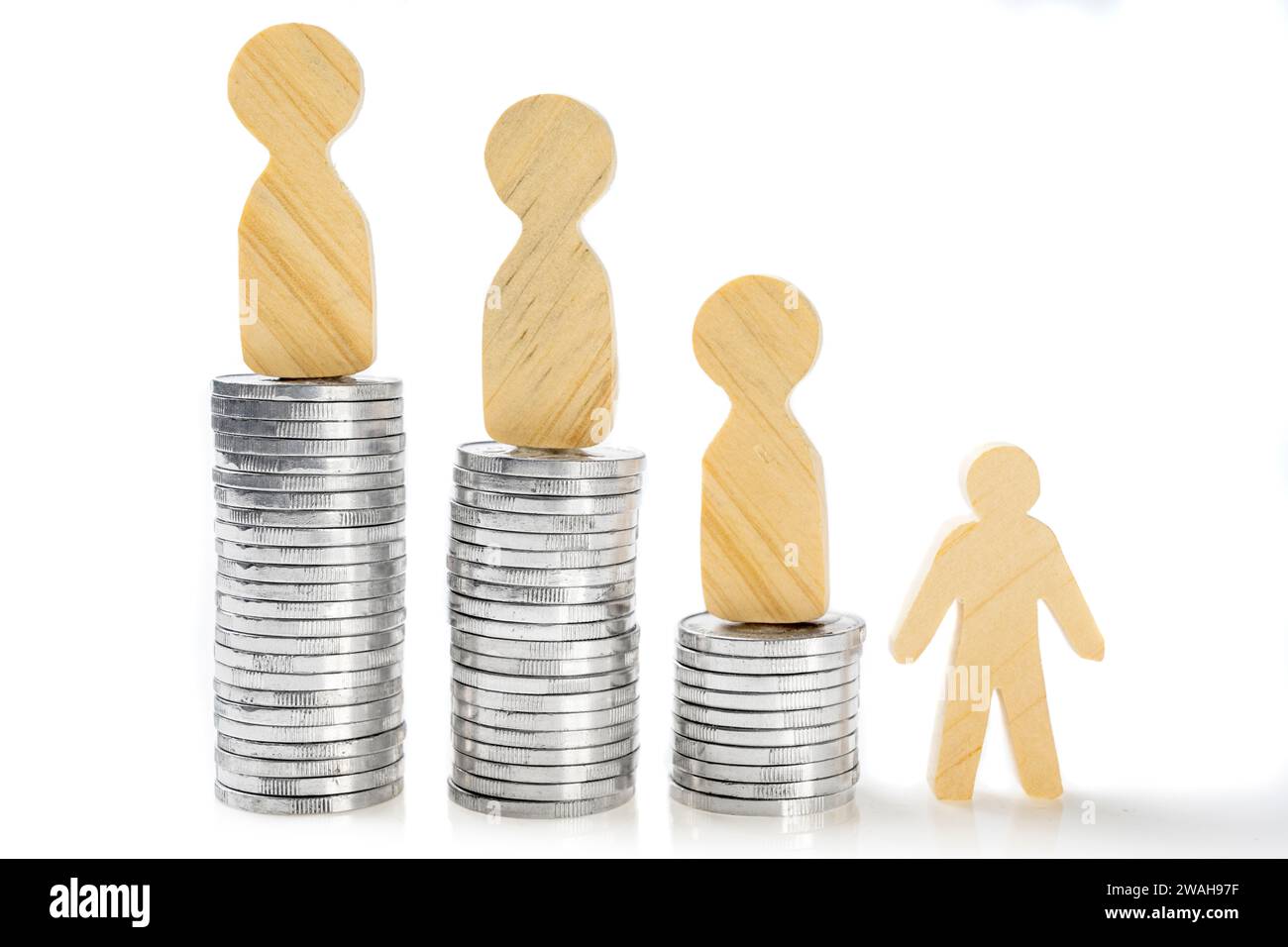 Stack Up Figure Closeup view of a wooden figure standing on a stack of silver coins ...