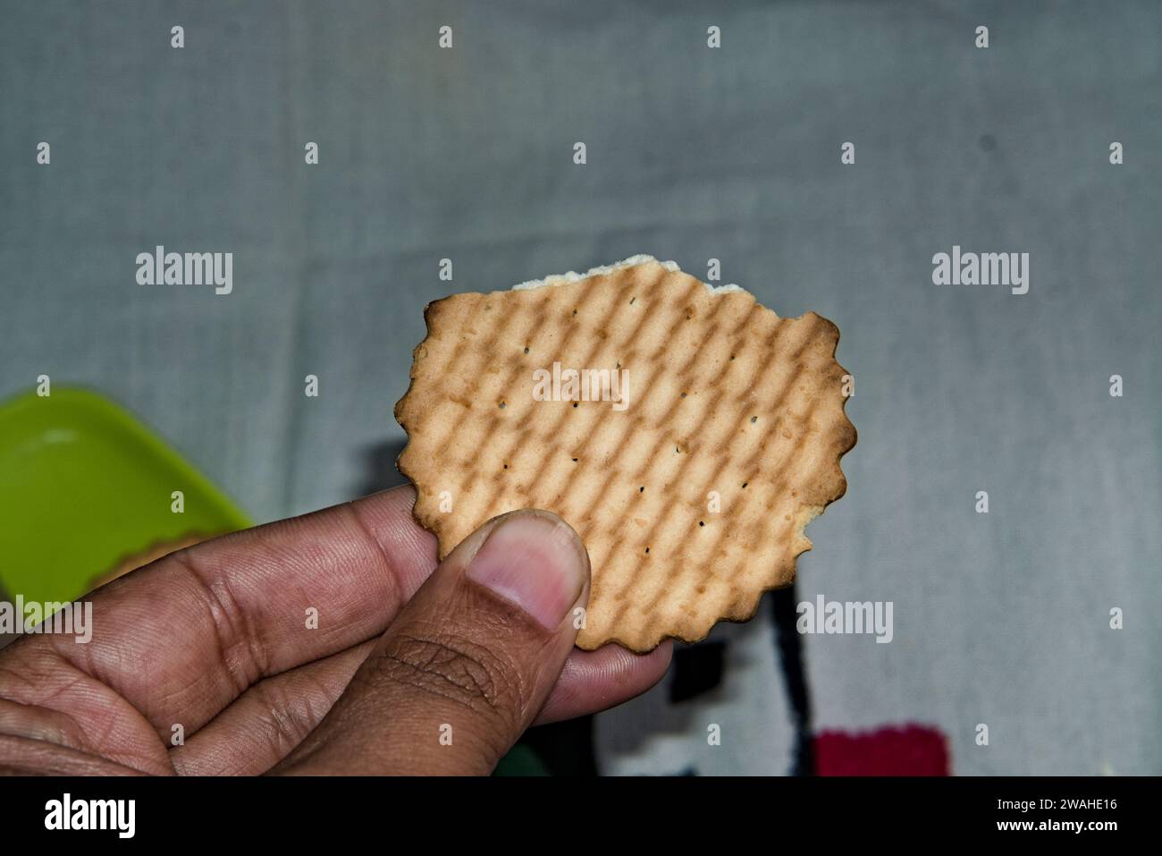 a hand holding a biscuit for breakfast in the morning Stock Photo