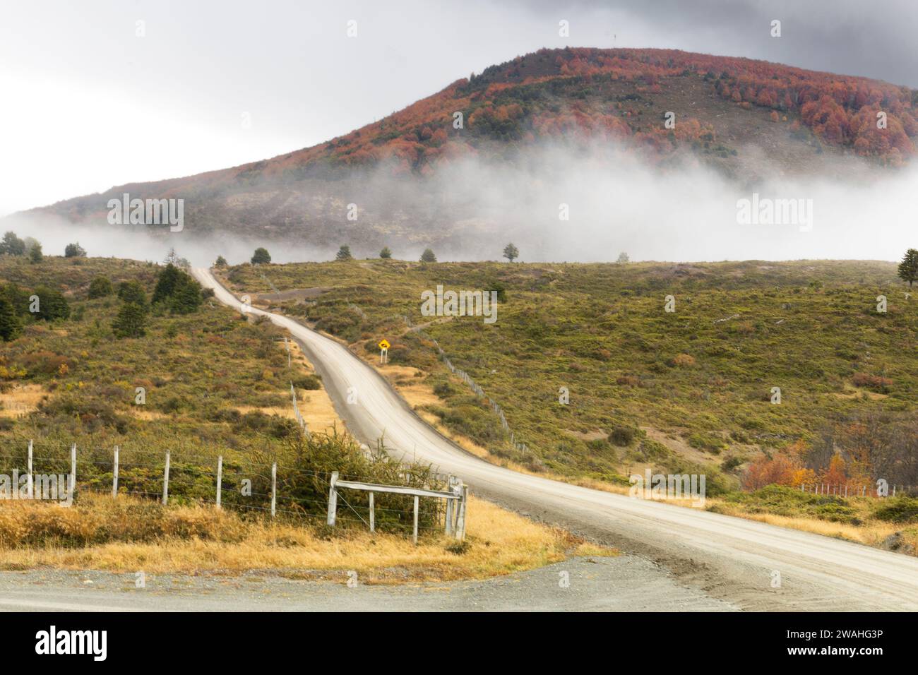 dirt road into a foggy mountain Stock Photo