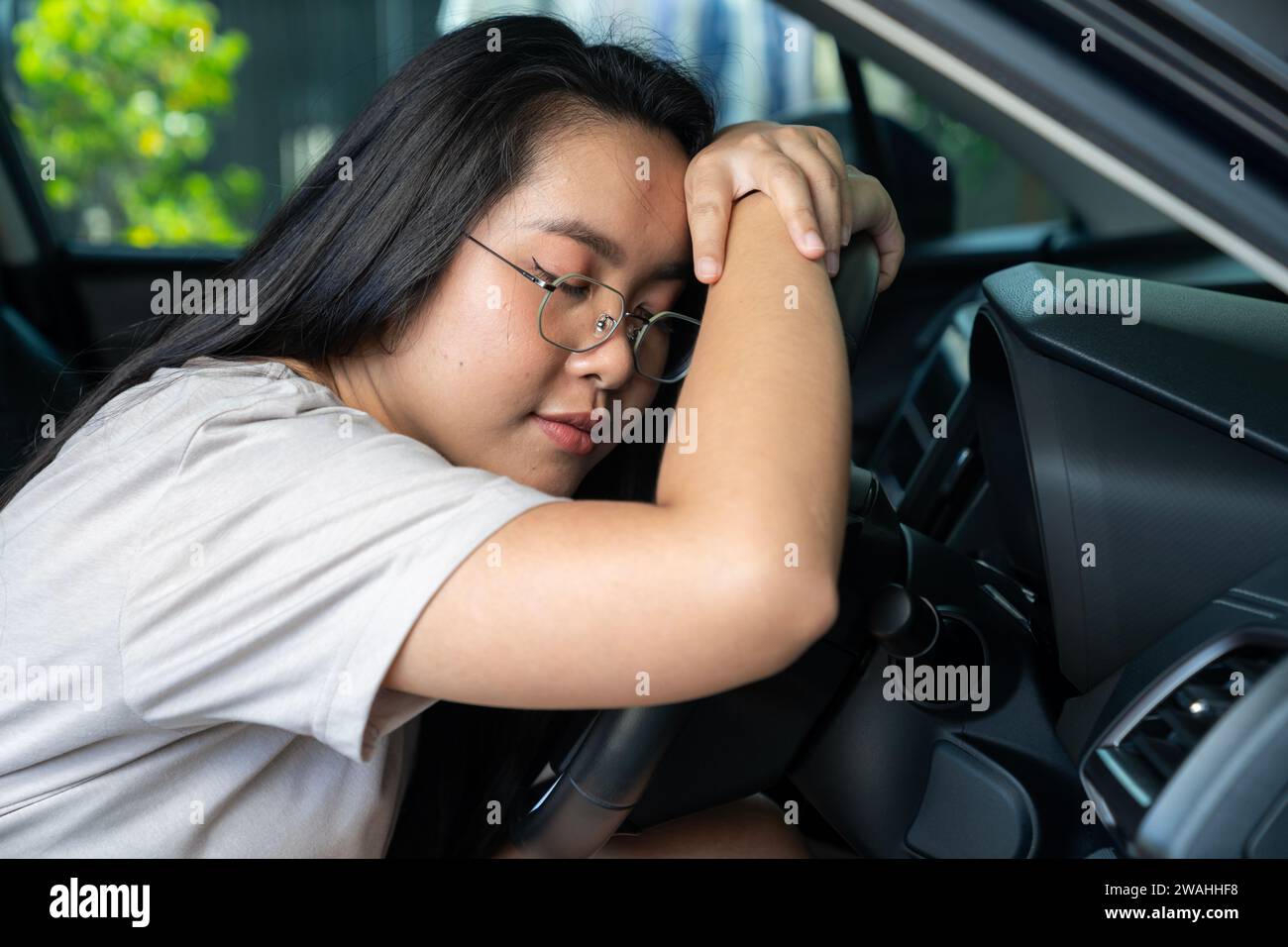 Young woman Asian are feeling sleepy while driving Stock Photo