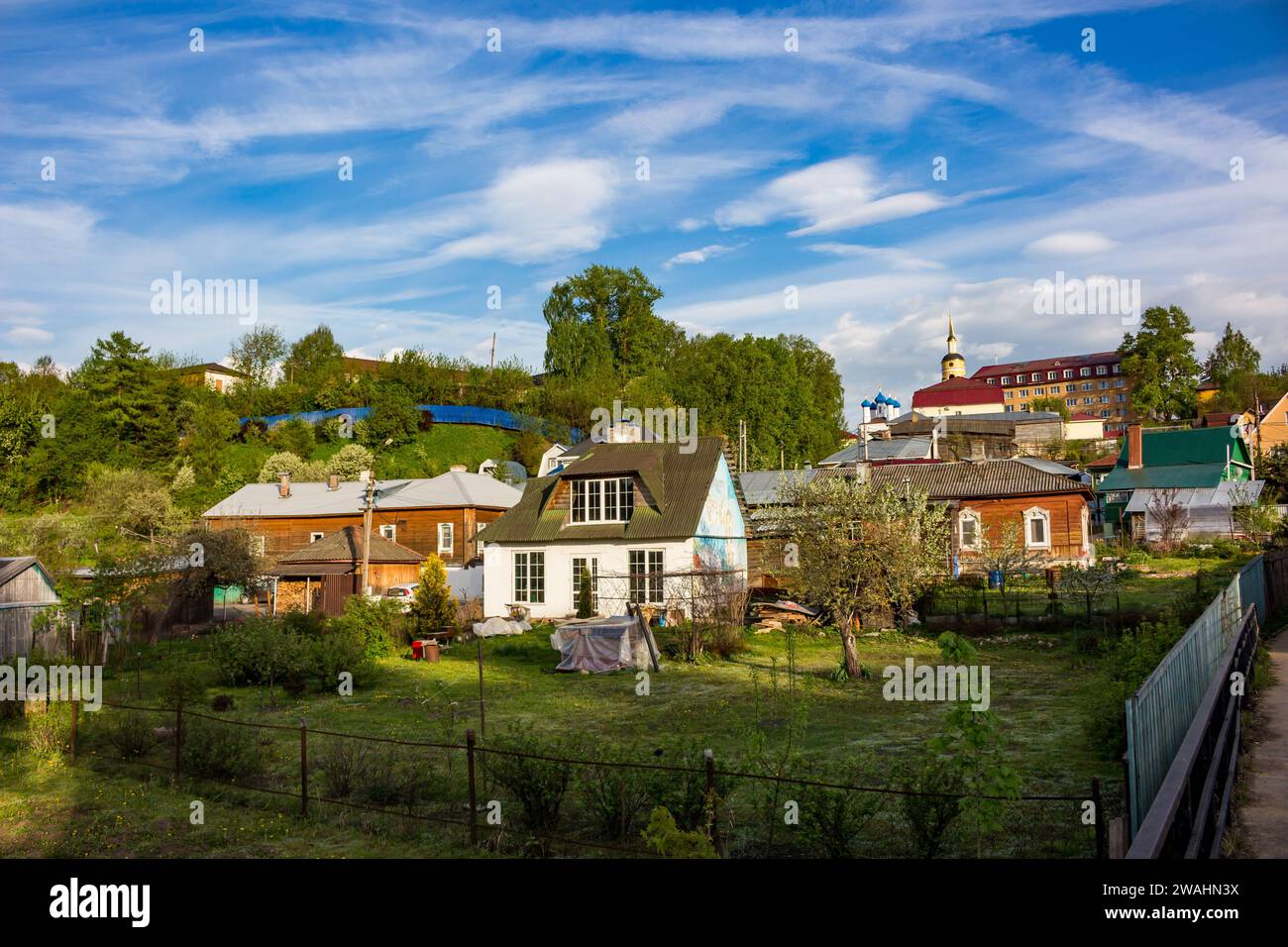 View of the picturesque rural buildings with houses and vegetable ...