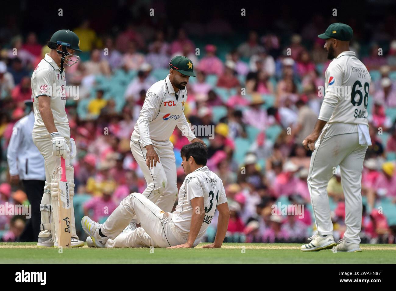 Sydney, Australia. 05th Jan, 2024. Mir Hamza lies on the ground after sustaining an injury while bowling during the match between Australia and Pakistan on the 3rd test match of Pakistan's cricket tour at the Sydney Cricket Ground (SCG). The Sydney Test is also known as the Pink Test. Current score: Pakistan 313&19/2 - 299 (Photo by Ayush Kumar/SOPA Images/Sipa USA) Credit: Sipa USA/Alamy Live News Stock Photo